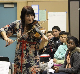 Students listen to the sounds of Beth Elliott's viola. Photo by Monica Hernandez 