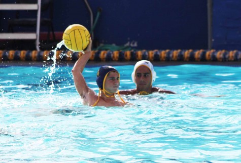 Senior Maxim Grinfeld arches back to shot the ball. The water polo team aims for city champions.