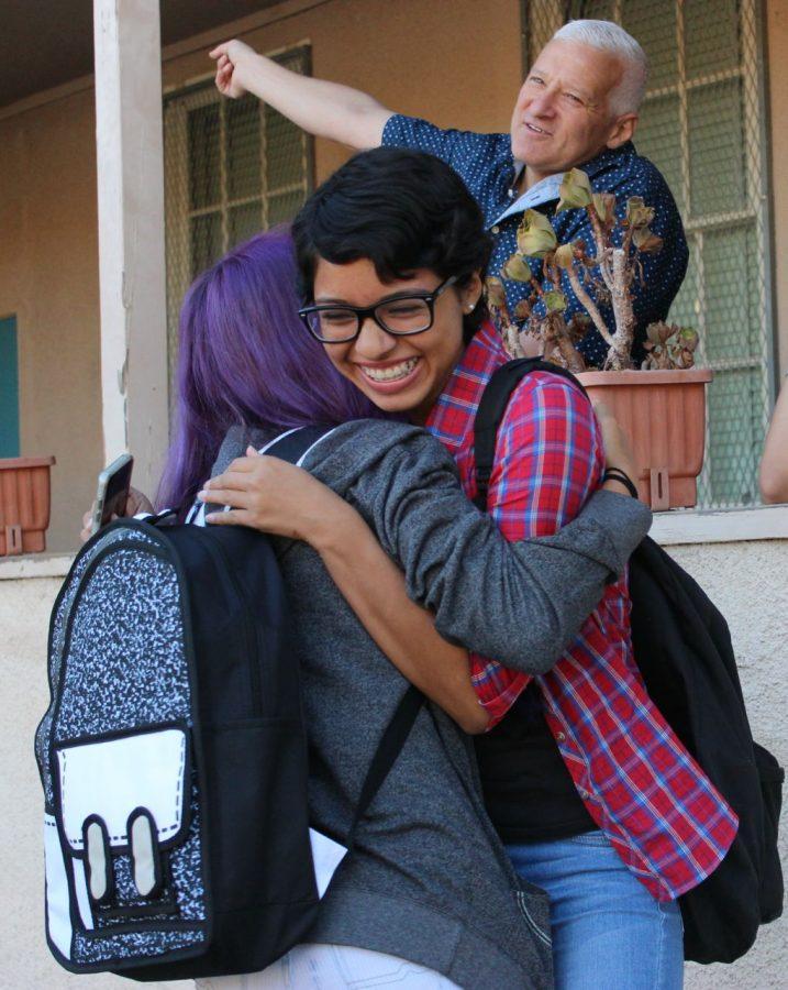 Junior Nixia Bravo hugs friend Katilyn Arst on the first day of school.