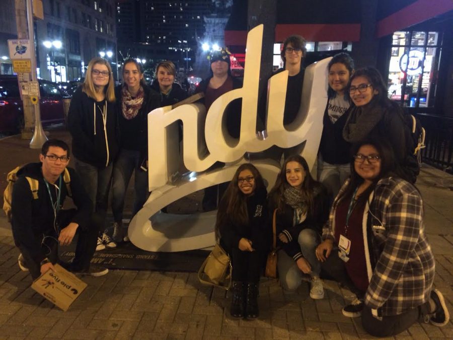 Students pose next to an Indy statue on Saturday night.