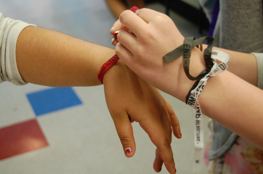 A student ties a bracelet that promotes an anti-bullying message for Bullying Prevention Month.
Photo By Dion Mazor