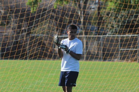 Junior Michael Linan puts on his gloves as he mentally readies himself for his last practice before Mar. 11 CIF Playoff Championship match versus Bell High School. Photo by Angelo Marmol.