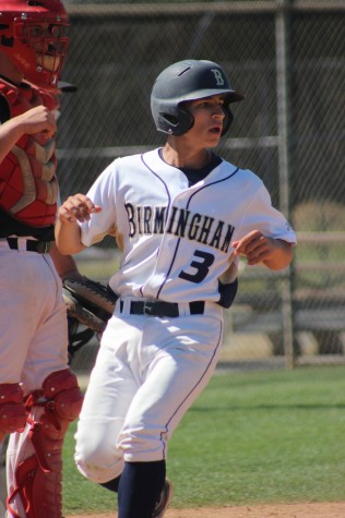 Varsity player, Raymundo Ruvalcaba steps on the home plate securing a point for the Birmingham Patriots during a game versus Cleveland High School.   Photo by Hailey Pohevitz