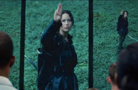 As the Captiol crumbles and Katniss' rebellion gains more and more strength, the symbol of the Mockingjay and Katniss' iconic three-finger salute become more prevalent in the outlying districts- and more powerful. Photo from mockingjay.net