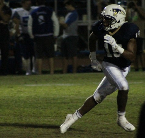 Linebacker Eric Flowers, No. 15, begins to sprint to respond to the ball during Birmingham Community Charter High School's homecoming game against El Camino Real Charter High School on Oct. 10. The Patriots came from behind to win the game 19-14. 