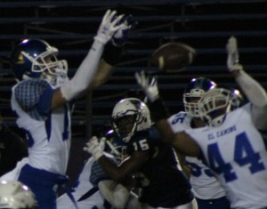 No. 15 Eric Flowers locks his vision on the ball while holding off an El Camino Real player during Birmingham Community Charter High School's homecoming game on  Oct. 10. Photo by Jake Dobbs