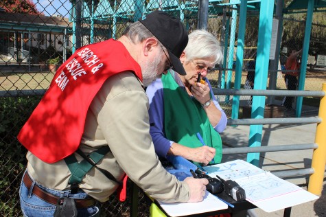 Science teacher Stephen Schaffter and School Administrative Assistant Diane Sieger practice setting up the earthquake command post in the front of the school. Photo by Melyssa Montoya. 