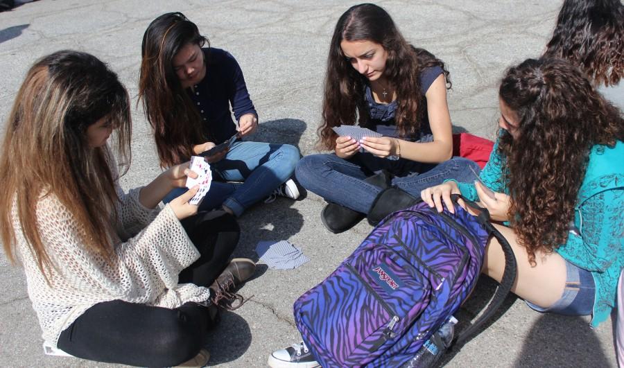 Students pass the time with a deck of cards waiting for the annual Great Shakeout to finish. Photo by Jessica Berrios.