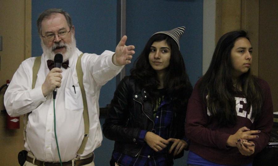 Science teacher Stephen Schaffter talks to the Hersey house members about the new House Elements. Prefecs senior Yasmine Saraf and Junior April Serrano stand after handing out award.