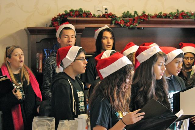 Alumni Carlos Godoy, Yvonne Gonzalez, and Daniella Valdivia sing holiday songs with the choir at the Lake Balboa Care Center. 
