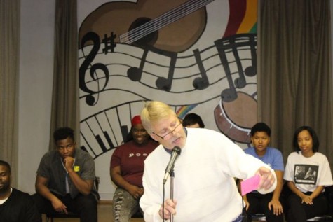 Physical Education teacher Robert Bryan reads a quickly written poem for students during the Get Lit assembly. Get Lit aims to make poetry more accessible to students and to get them involved in poetry competitions.