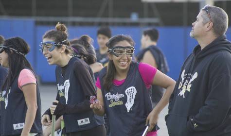 Senior Ana Perez, sophomore April Serrano and girls lacrosse Coach Scott Silva take a break for laughter during a hard working afternoon conditioning and practicing for the 2015 spring season.