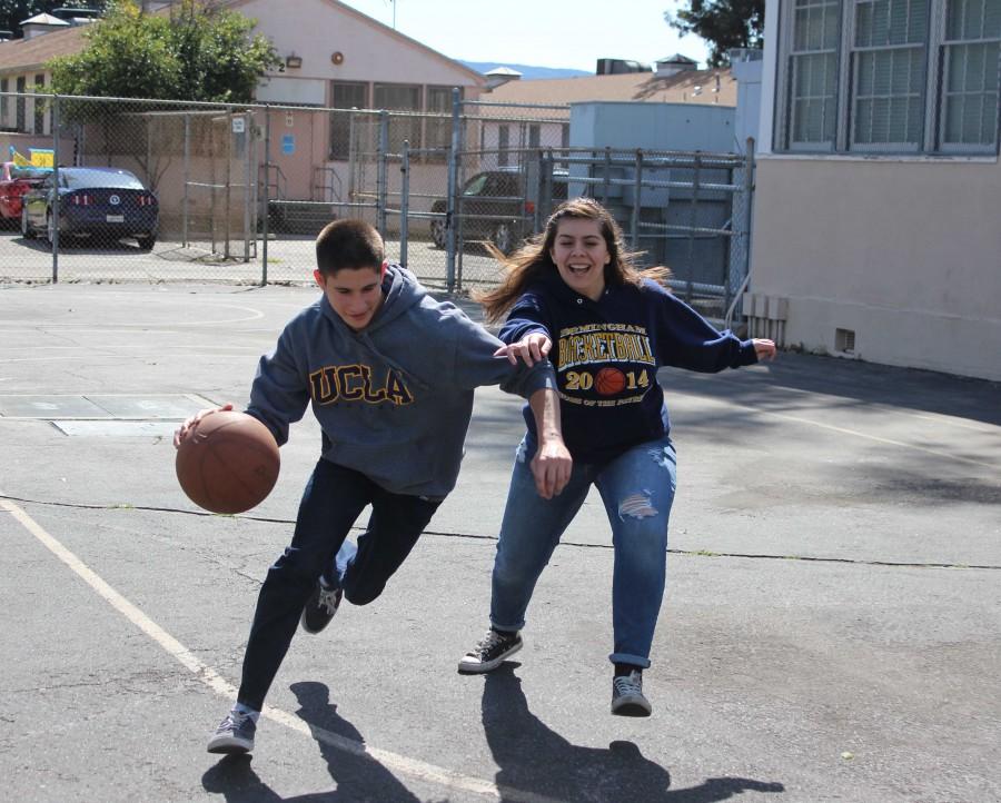 Junior Maxim Grinfeld dribbles past junior Jessica Ramos, a shooting guard for the BCCHS girls basketball team, in a one on one match during 6th period at DPMHS.