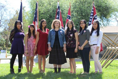 Senior Vanessa Fano, freshman Kailtyn Arst, Senior Amanda Arst, Senior Boa Pistol-Boesch, junior Saba Mahmoudi, junior Sheena Gonzalez and Jomari Reyes gather up in front of a display.