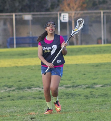 Sophomore April Serrano perfects her catching skills during drills.