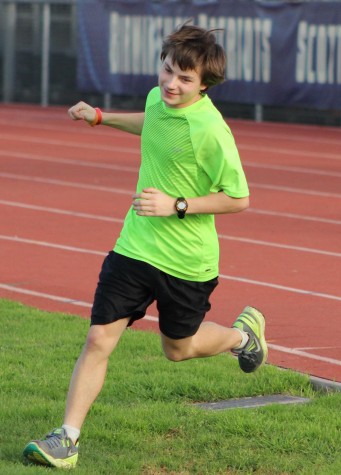 Sophomore John Ford runs off the track after his lap. 