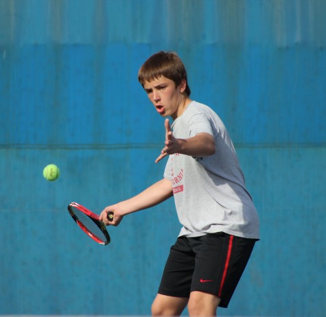 Sophomore Jozsef Feher positions his racket to return the tennis ball during practice on Birmingham's tennis courts. 