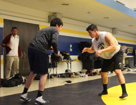 Junior Stanley Cea keeps his stance as his wrestling buddy gets ready to launch himself at Cea. 