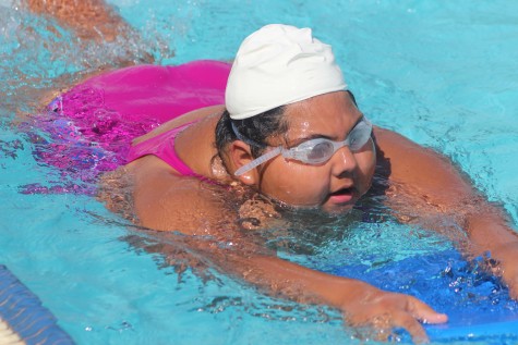 Sophomore Arianna Aguayo is strengthening her kick and legs with the kick board to improve her technique at Birmingham Community Charter High School’s swimming pool.