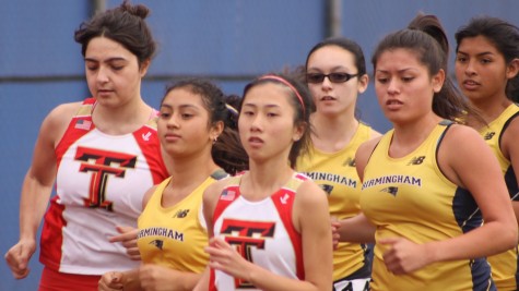 Birmingham runners Sherran, Savannah Orrill, Natalie and Kayla run alongside their competitors Taft runners during a track meet on April 22.