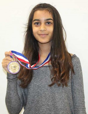 Freshman Kaitlyn Arst poses with her first place medal that she won at the California State Science Fair for her project on soil erosion.