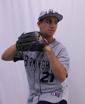 Varsity pitcher Roman Tomashoff sets arms in motion to pitch the ball. .