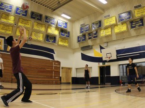 Sophomore Jonas Acebes and Jon Dumindin pass the ball back and forth alongside  varsity teammates.                                                                                                                                                                                                                                                                                                                                                                                                                                                                                                                                                                                                                                                                                                                                   