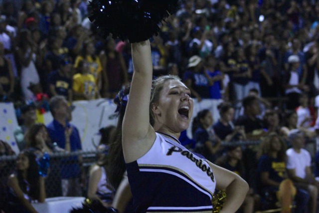 Cheerleader, Jamie Timsit and the crowd go wild as the football team runs toward the end zone. The next home game will on Sept. 25 against Oak Christian School. 
