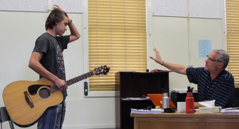 Freshman Zach Gephart-Canada listens to instructions from music teacher Wes Hambright during his audition for the show from Oct.8. Hambright auditioned students for the show in his classroom on Oct. 8 and 9.