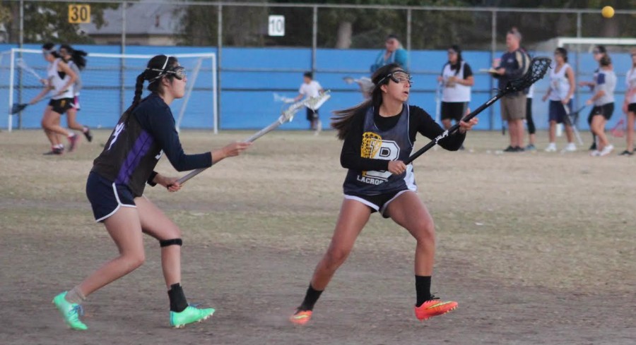 Junior April Serrano avoids her defender while catching the ball during tryouts. 