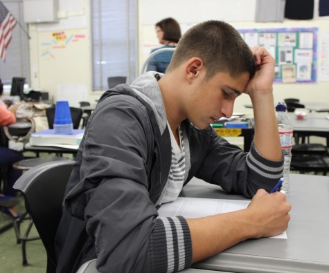 Senior Maxim Grinfeld works on a handout during a monthly math competition. 