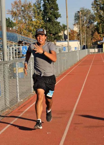 Senior Pedro Morataya shows his Shark pride while running down the track.