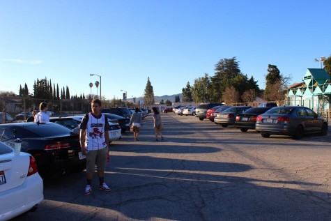 Senior Jeremy James waits in the parking lot with his friends after they parked their cars before school starts. By this time, the parking lot is full and students and staff have to search for spaces in order to be in class on time.