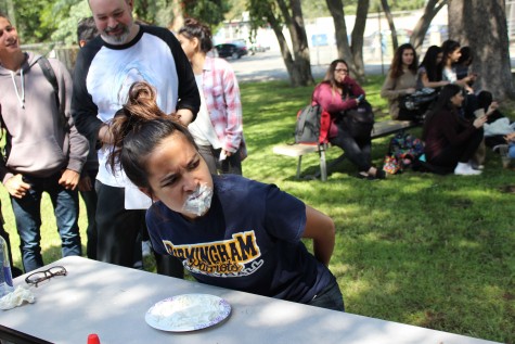 Senior Michal Francisco participates in the pie eating contest during Fiesta Friday.