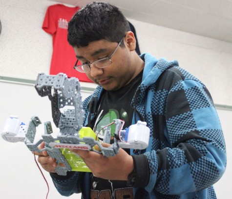 Junior Matthew Martinez tinkers with his group robot, challenging his thought process and math skills.