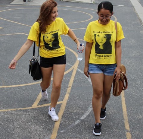 Seniors Valentina Comar and Sindy Saravia walk beside each other clad in their Rebecca Becerra shirts in remembrance of her. Bacerra committed suicide last year in May. Students were deeply impacted by her death and adorn themselves in yellow ribbons to fight teen suicide. 
