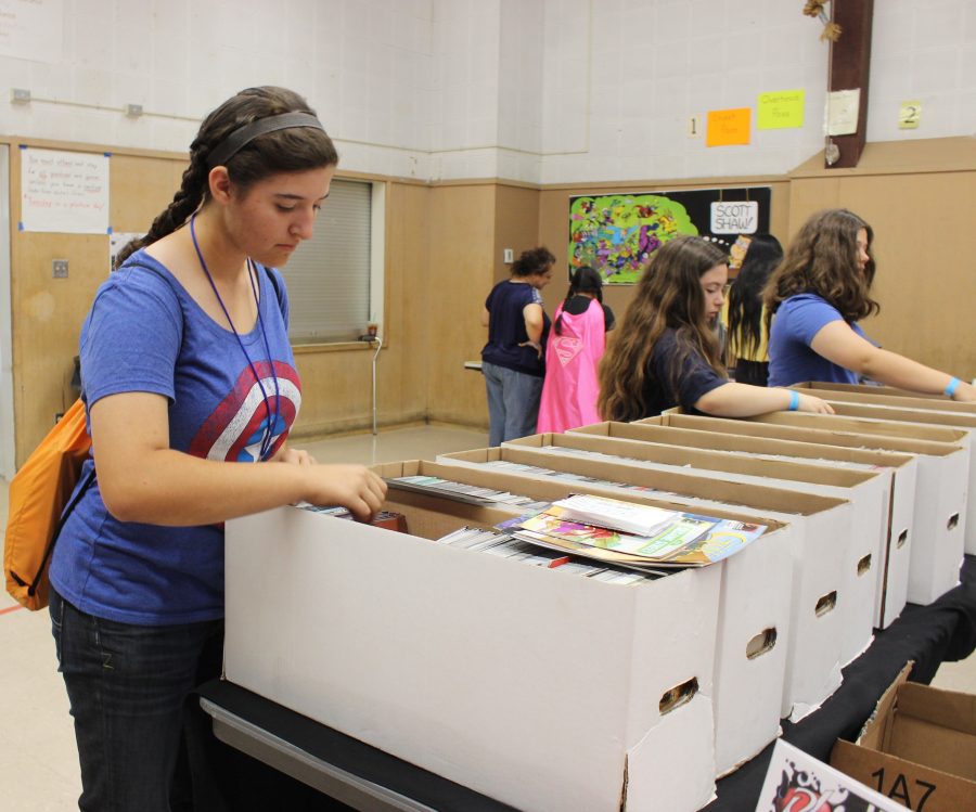 Sophomore Rachel Bullock searches through boxes of comic books from DJs Universal Comics. 