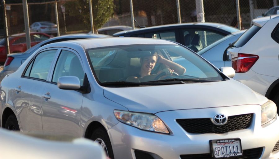 Senior Gera Pminenov waits to park in the Daniel Pearl Magnet High School parking lot. Students say that parking this year is easier
than last because there are fewer student drivers.