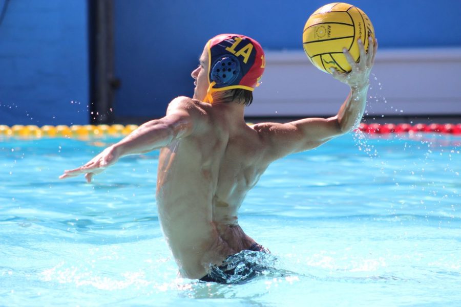 Sophomore Zachary Gephart-Canada prepares to pass the ball down the pool to his team mate.