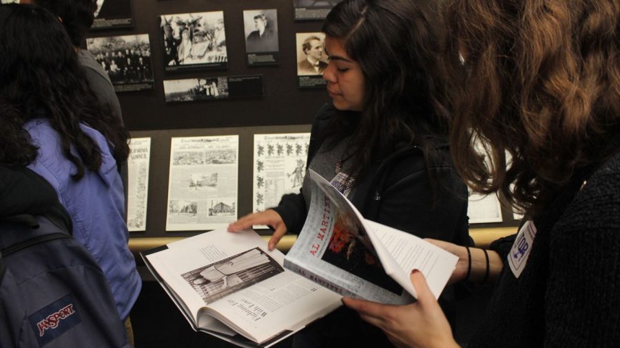 Jercan and Salguero look through books of past and current reporters of the L.A Times and all the work they've done.