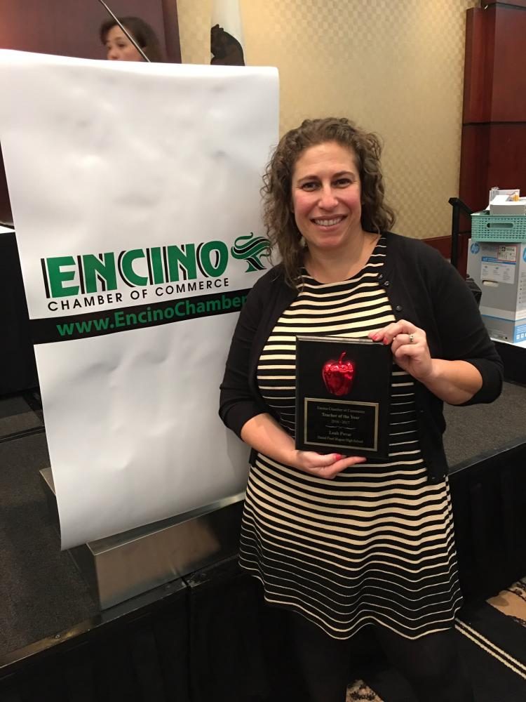 English teacher Leah Pevar holds her award for being recognized as Teacher of the Year for Daniel Pearl Magnet High School.