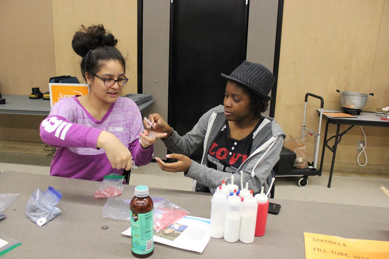 Francheska Vicents and Jade Ajileye construct WAPIs that are to be sent Mexico to help people find clean water.