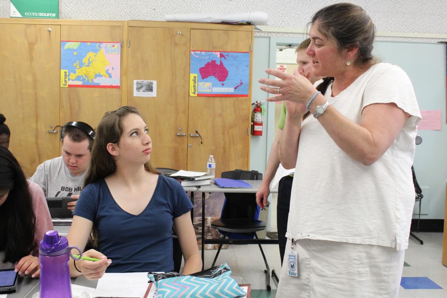 Stephanie Wolfson, director of education for the David Labkovsky Project, works with sophomore Hailee Kessler in prepara on of the student run exhibit. 