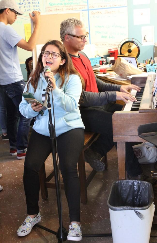 Senior Ana Monterroza sings while music
teacher Wes Hambright plays the piano.