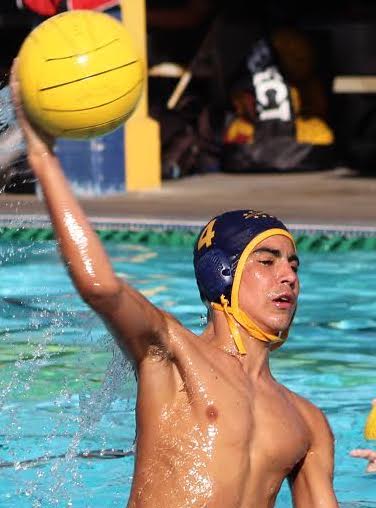 Sophomore Ben Sanchez handles the ball in a water polo game in the fall.