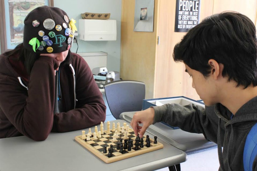 Senior+Tyler+Loring+intently+watches+sophomore+David+Mallari+make+his+next+move+during+a+Chess+Club+meeting.