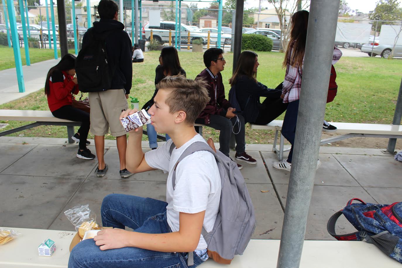 Freshman Ethan Zinshteyn enjoys a sip of chocolate milk during lunch.