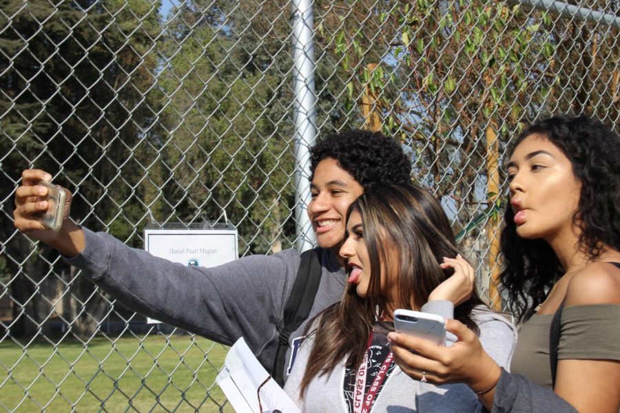 Andres Perkins, Briana Ayala and Elizabeth Ramos take a photo during the Great California ShakeOut on Oct. 19. 
