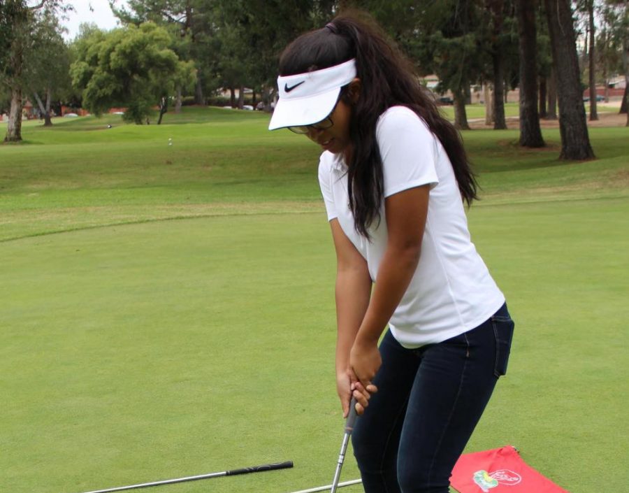 Junior Astrid Cabrera swings for a hole in one to prepare for the new season.