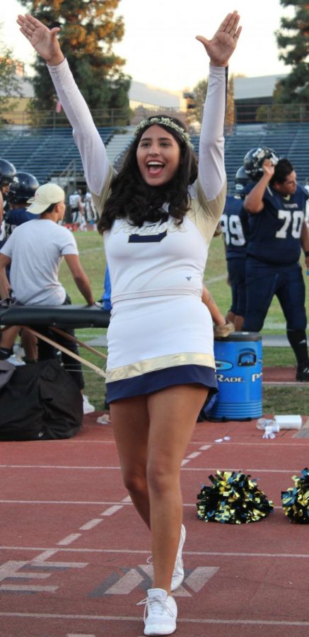 Freshman Gabriela Gomez does a cheer with her team before the Homecoming game. The Birmingham Patriots beat the Cleveland Cavaliers 41-6.
